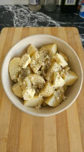 butter and seasoning on potatoes