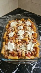 Layered unbaked Baked Ziti Recipe in a baking dish.