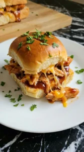 Single served BBQ Chicken Slider with melted cheddar and saucy shredded chicken.