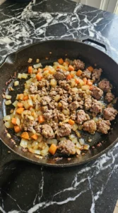 Ground lamb browned with yellow onion and carrot for Shepherd’s Pie