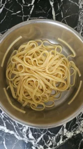 Fettuccine softening in a large pot for chicken alfredo.