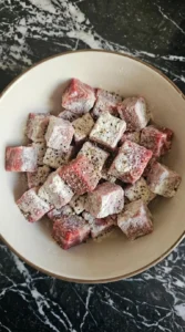 Beef chuck roast coated with flour for Irish Beef Stew