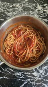 spaghetti mixed with sauce