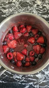 Mixed berries softened into a glossy topping for Cottage Cheese Protein Bowl