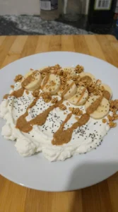 Banana granola and chia layered over creamy base for Cottage Cheese Protein Bowl