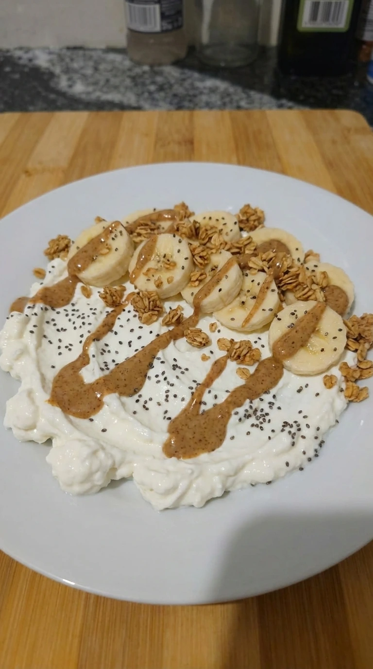 Banana granola and chia layered over creamy base for Cottage Cheese Protein Bowl