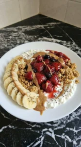 Finished Cottage Cheese Protein Bowl with warm berries and almond butter
