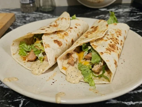 creamy garlic chicken wraps with melted cheese and sauce