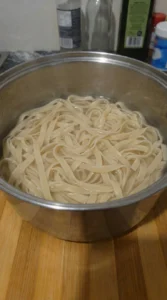 Fettuccine softening in water for Creamy Garlic Parmesan Pasta.