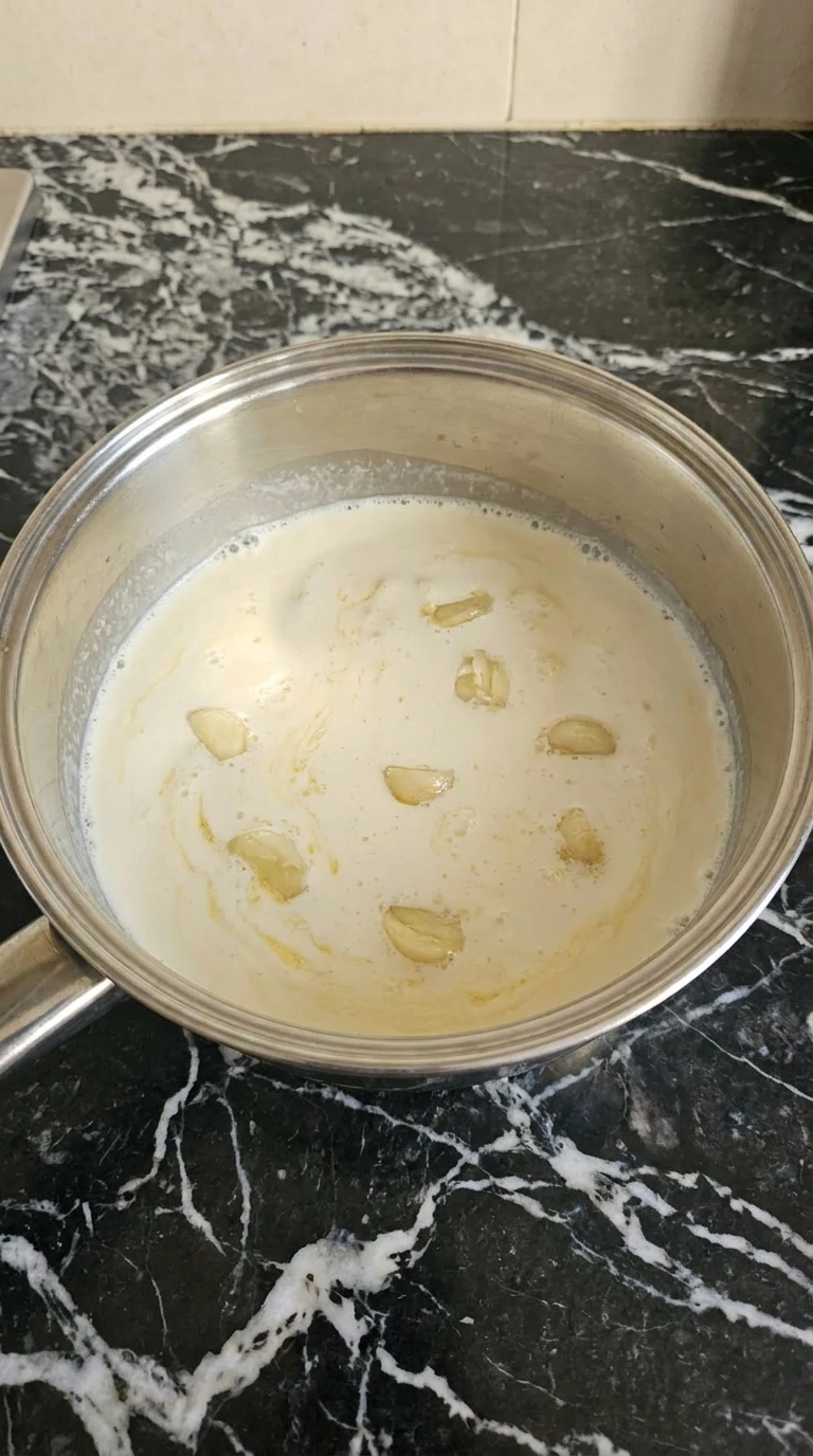 Garlic and cream simmering for Creamy Garlic Parmesan Pasta.