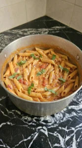 Penne folded into creamy tomato sauce with parmesan and basil.