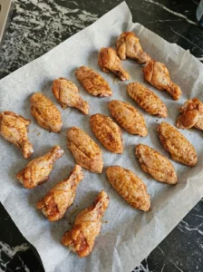 Arranging seasoned wings on a tray