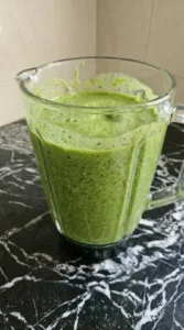 Detox Green Smoothie blended until smooth and frothy in blender jar