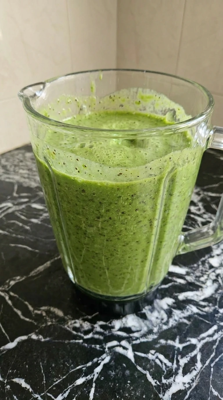 Detox Green Smoothie blended until smooth and frothy in blender jar