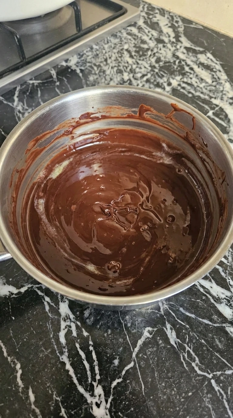 Chocolate and butter melted into a glossy mixture for Easy Chocolate Lava Cake.