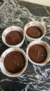 Chocolate batter portioned into ramekins for Easy Chocolate Lava Cake.