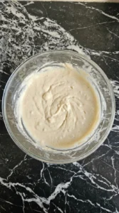 Pancake batter mixed to a pale creamy texture with a few lumps