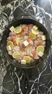 chicken browning unevenly with softened lemon slices