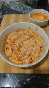 Raw chicken coated in thick seasoned marinade