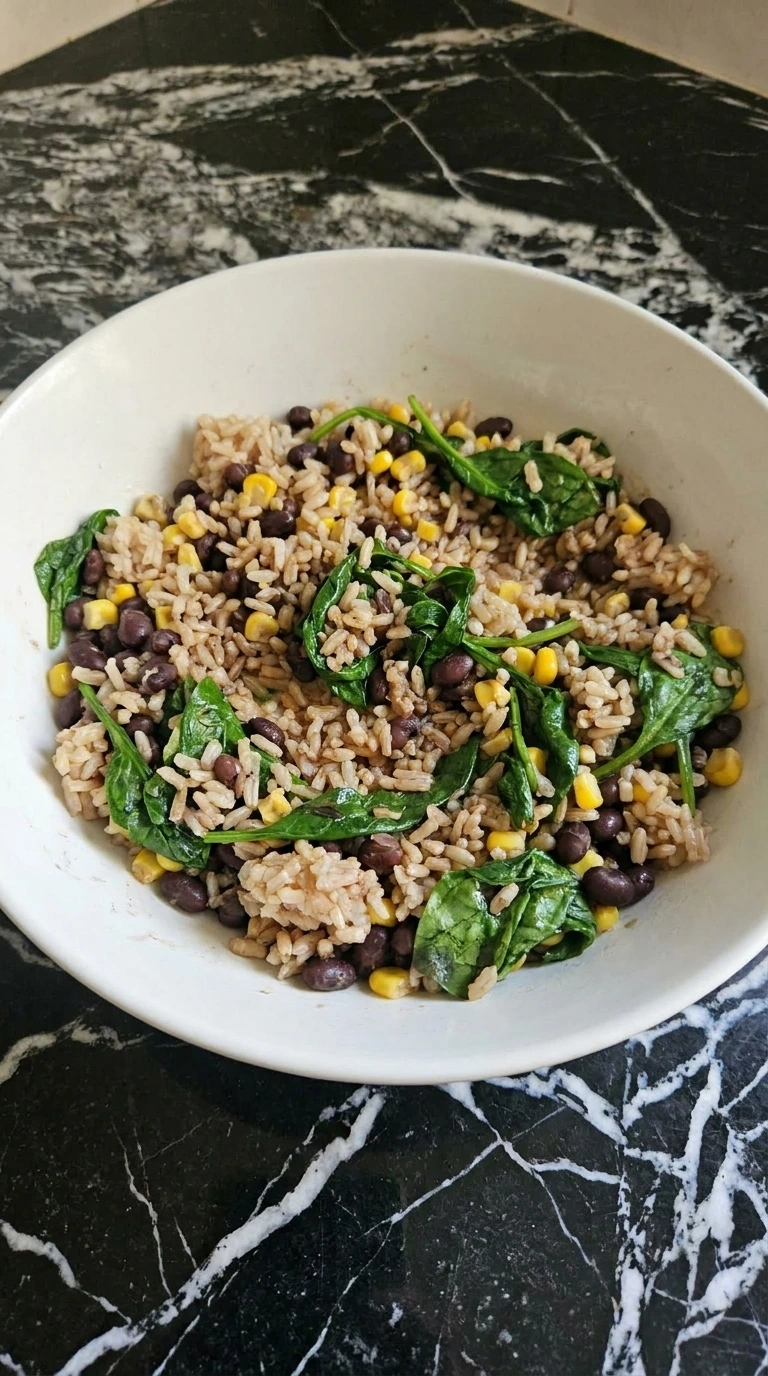 Rice, beans, corn, and spinach mixed for the bowl base
