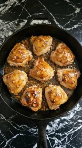 Chicken simmering in thick honey garlic glaze.