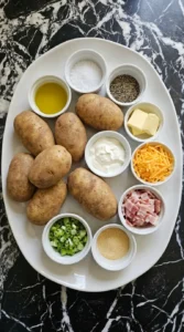 Measured ingredients for loaded baked potatoes on a white stoneware platter
