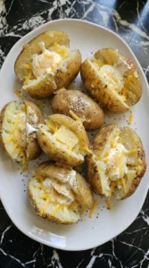 Creamy potato filling partially mixed inside split potatoes