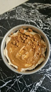 Cheesecake filling spread over Biscoff crust in soft uneven waves.