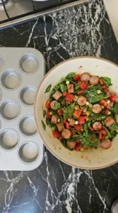 Seasoned vegetables and sausage coated lightly with oil for egg muffins