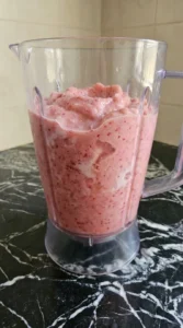 Thick pink Raspberry Colada mixture blended in a jar
