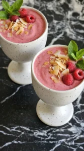 Raspberry Colada topped with toasted coconut raspberries and mint