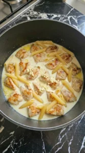 Penne softening in creamy sauce with chicken for One Pot Chicken Alfredo Pasta