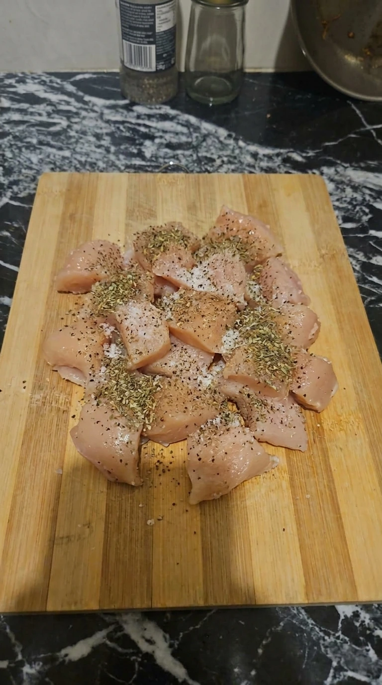 Boneless chicken breast pieces seasoned for One Pot Chicken Alfredo Pasta