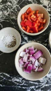 Measured ingredients for mac and cheese in bowls