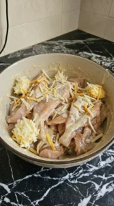 cheese scattered over chicken mixture
