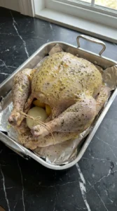 Raw turkey coated in seasoned herb butter
