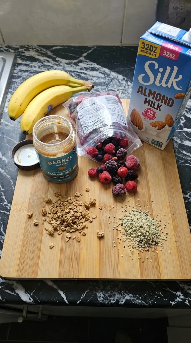 Raw ingredients for a berry smoothie bowl including bananas and berries