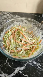 Creamy white coleslaw dressing in a small glass bowl.