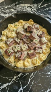 Steak and tortellini in creamy garlic sauce