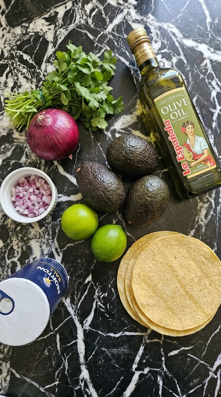 Raw ingredients for guacamole and chips including avocados, limes, and tortillas