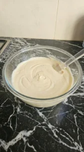 Finished vanilla cupcake batter in a clear glass bowl