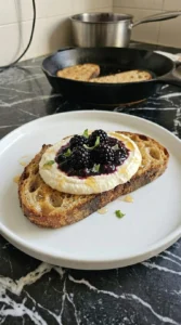 Golden sourdough layered with whipped ricotta and blackberry jam
