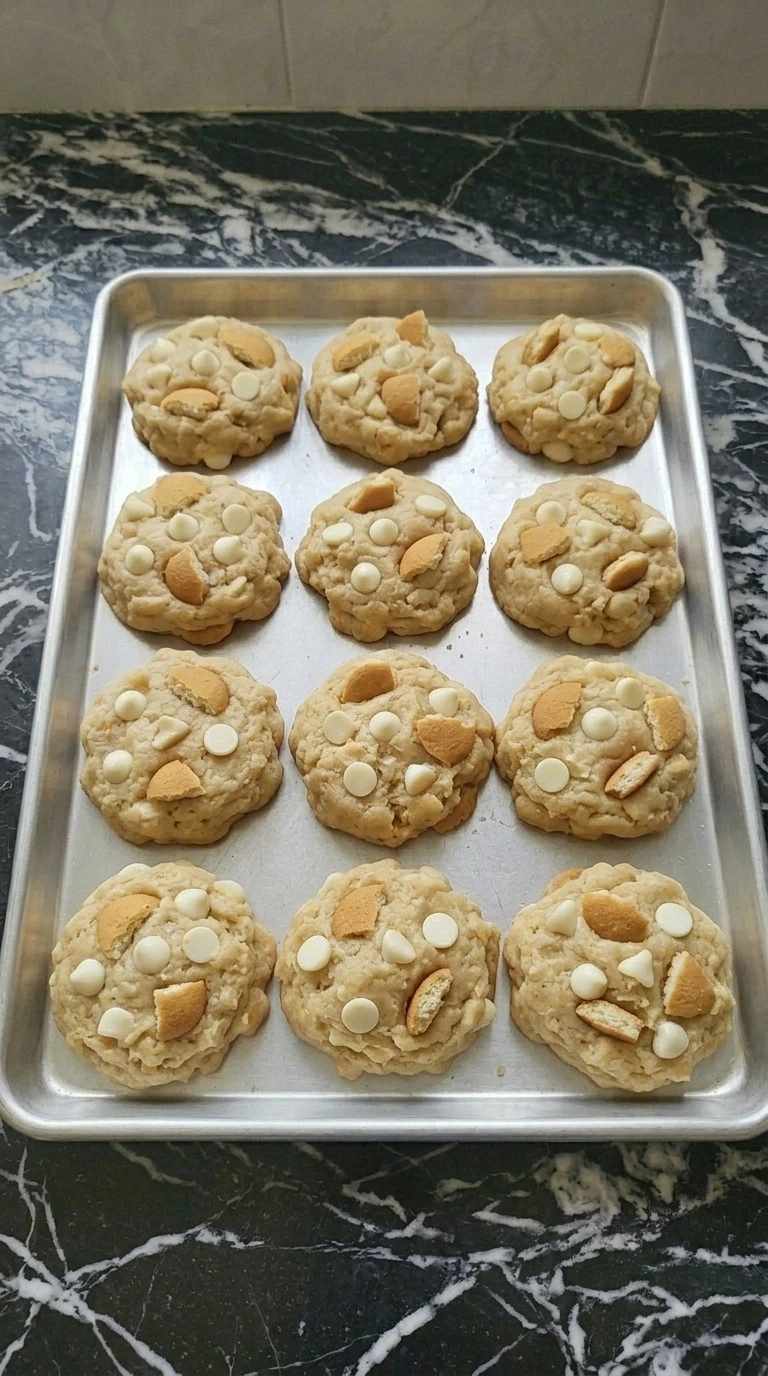 Fresh baked banana pudding cookies with golden edges on a tray