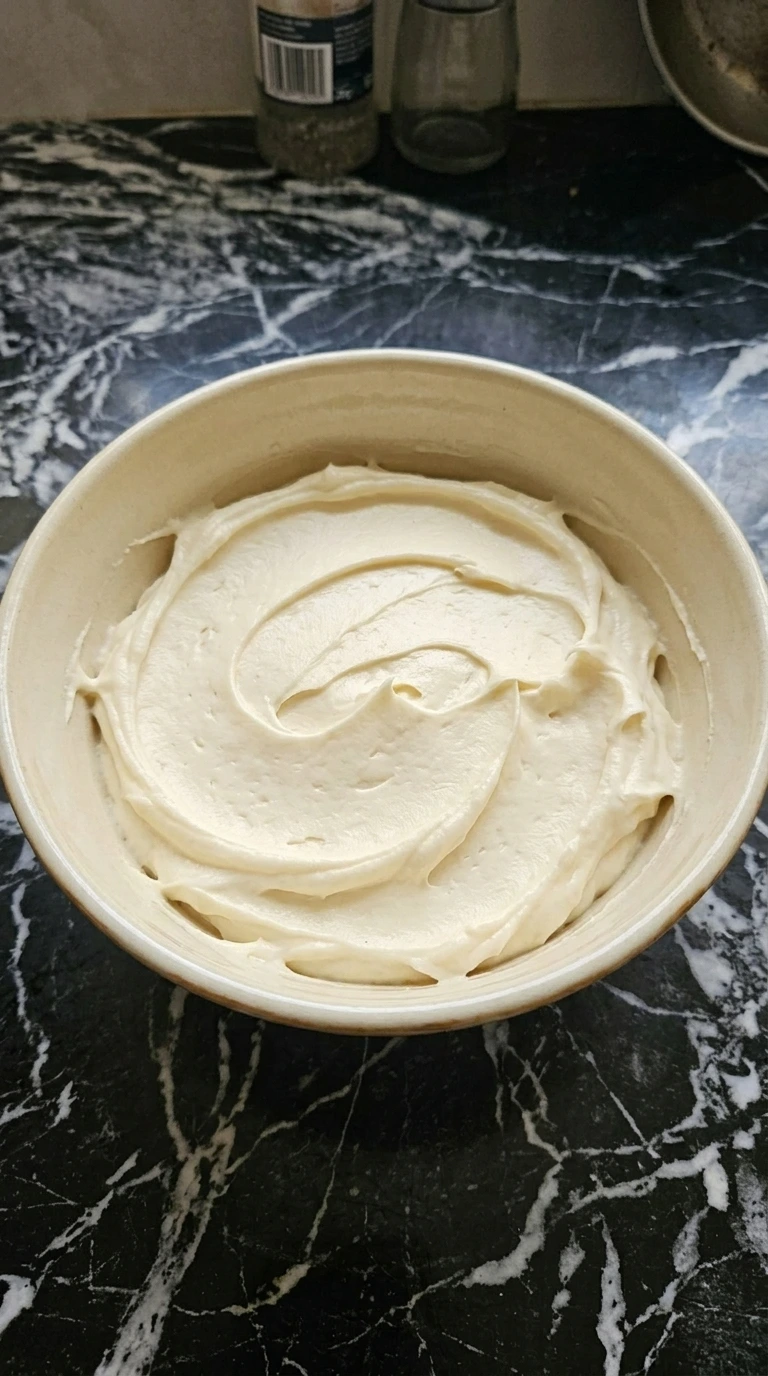 Pale ivory cream cheese frosting whipped smooth for Banana Cake.