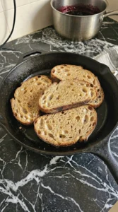 Four thick sourdough slices toasted in butter until deep golden