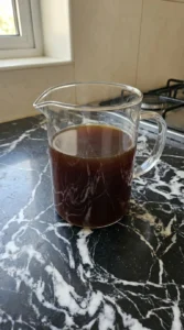 Chilled dark coffee base resting in a glass pitcher