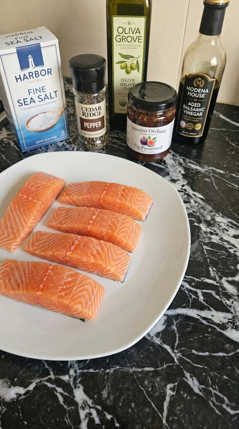 Ingredients for Fig Balsamic Salmon arranged in separate plates and labeled packages. Recipe focus: Goat Cheese Crusted Chicken.