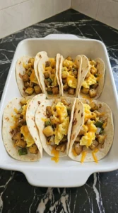 Eight flour tortillas filled with potatoes eggs and sharp cheddar