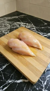 Raw chicken breasts coated in olive oil