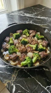 Ground beef and broccoli stir-fry cooking in a dark sauce